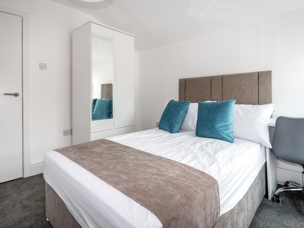 Bright and cozy double bedroom featuring a comf...