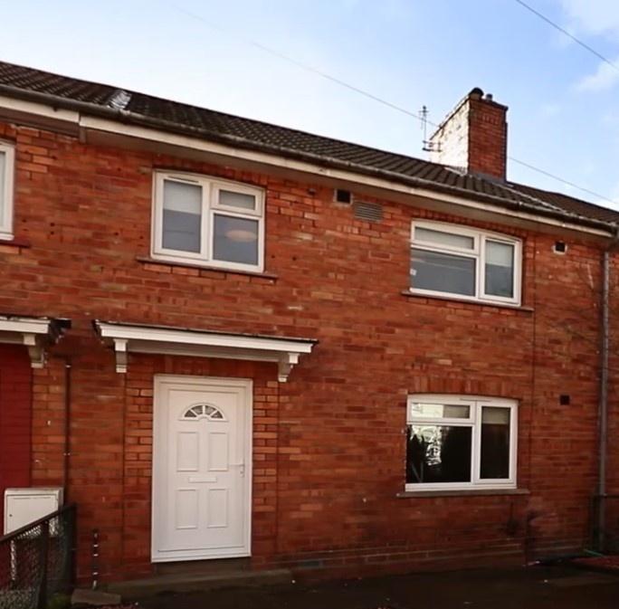 A charming terraced brick house with a clean wh...