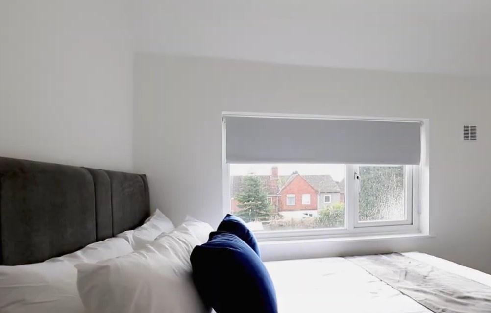 Bright and cozy double bedroom featuring a comf...