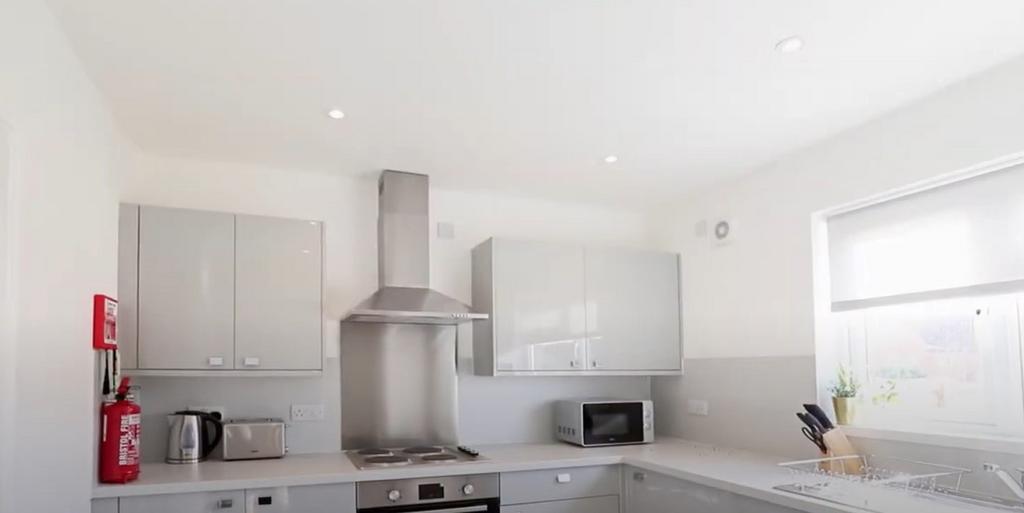 Bright and modern kitchen featuring sleek white...