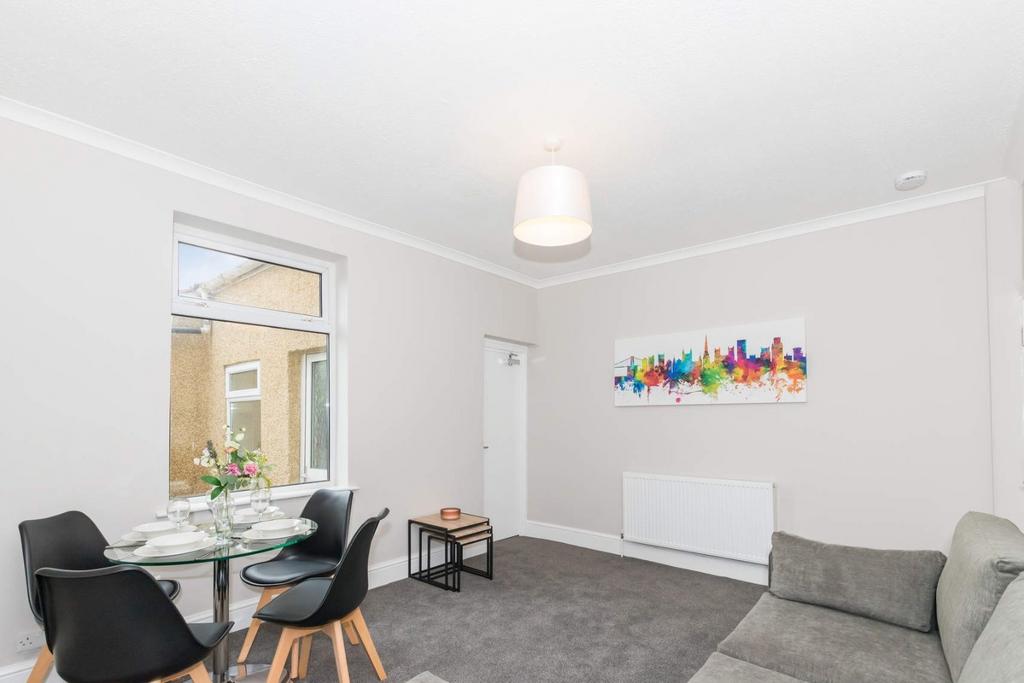 A bright and inviting living room featuring a c...