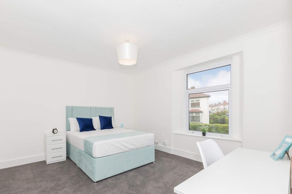 This inviting double bedroom features a comfort...