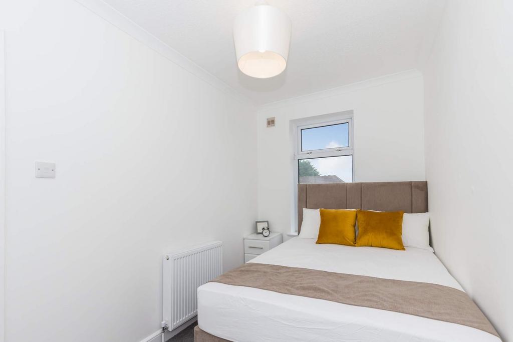 This inviting double bedroom features a comfort...
