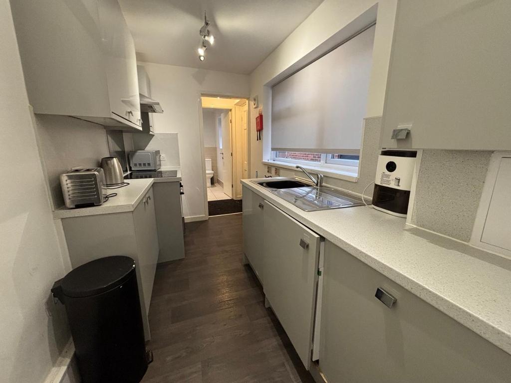 Modern kitchen featuring sleek cabinetry, ample...