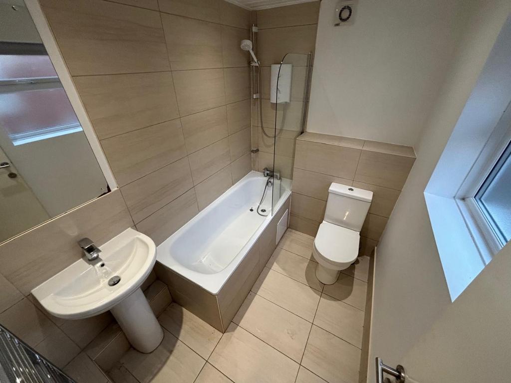 A modern bathroom featuring a sleek bathtub, a ...
