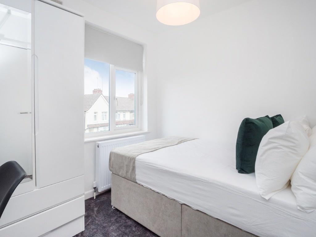 A bright and inviting double bedroom featuring ...
