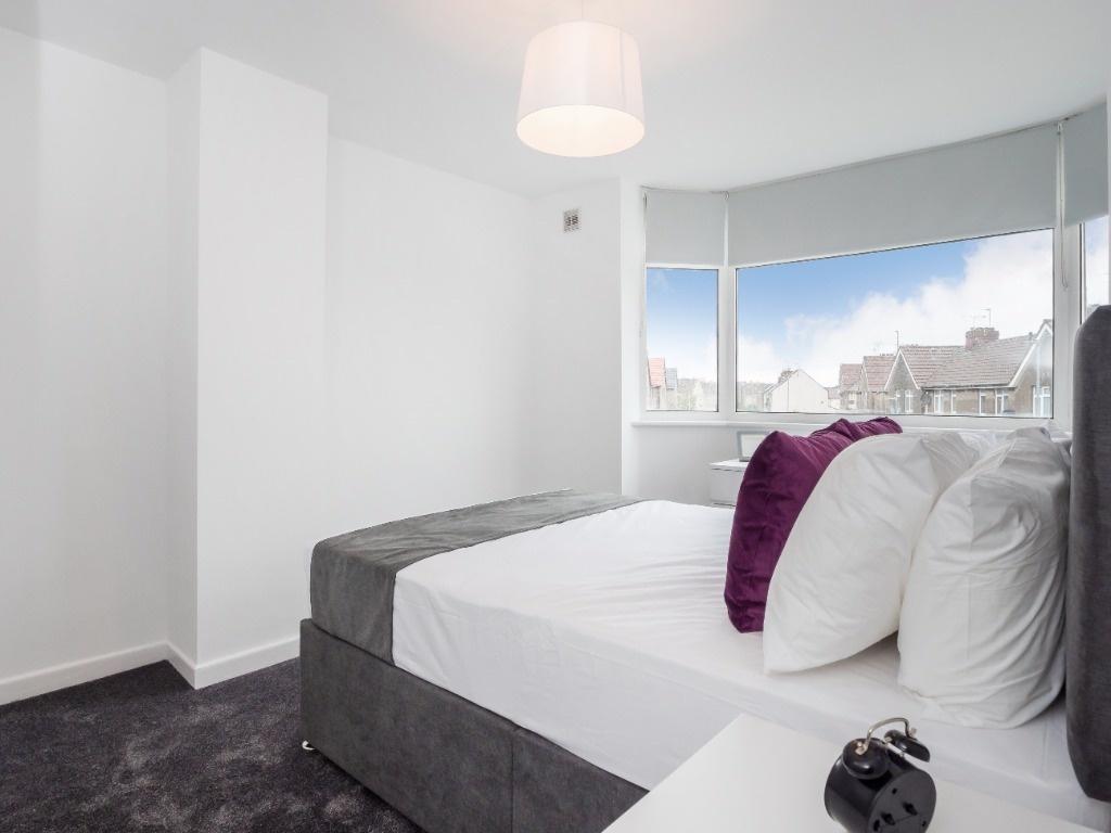 This inviting double bedroom features a stylish...