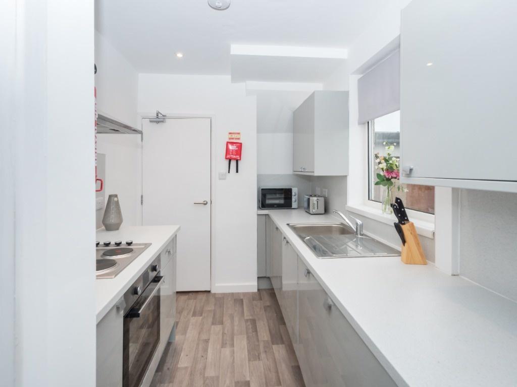 This modern kitchen features sleek cabinetry an...