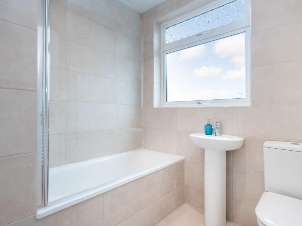 A modern bathroom featuring a clean design with...