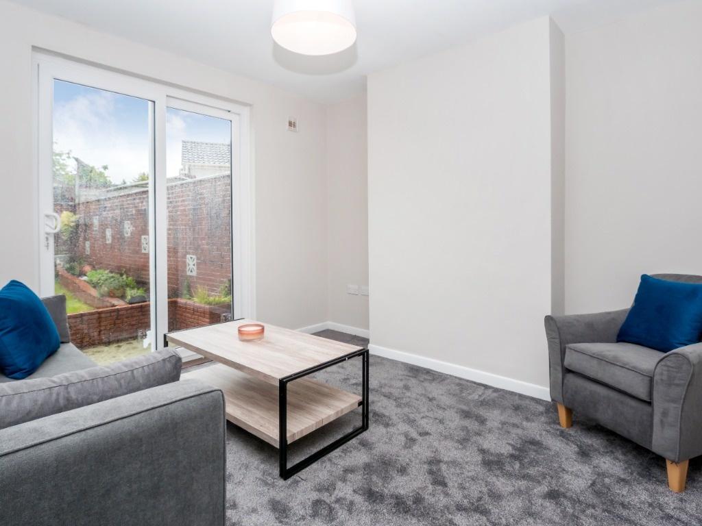 Bright and inviting living room featuring comfo...