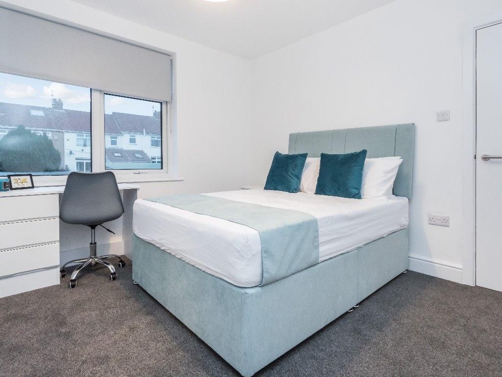 A bright and modern double bedroom featuring a ...