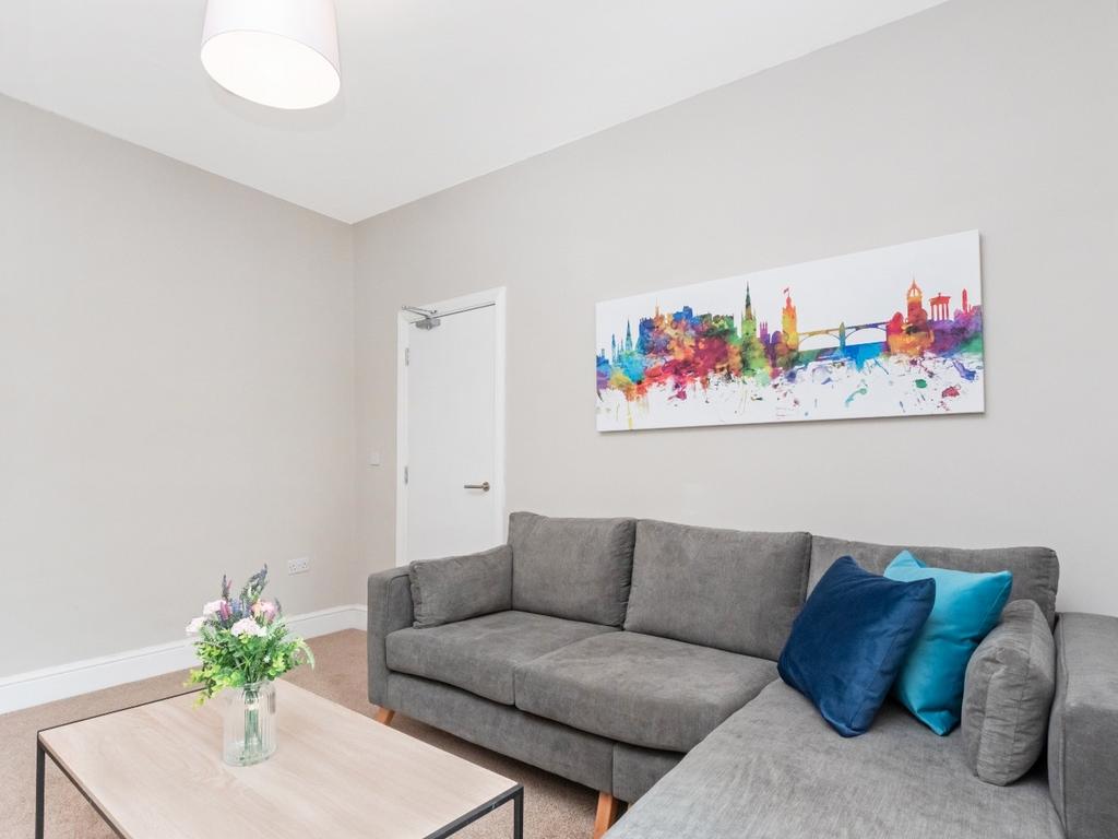 A stylish living room featuring modern decor, a...