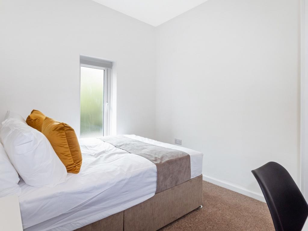 This inviting double bedroom features a cozy am...