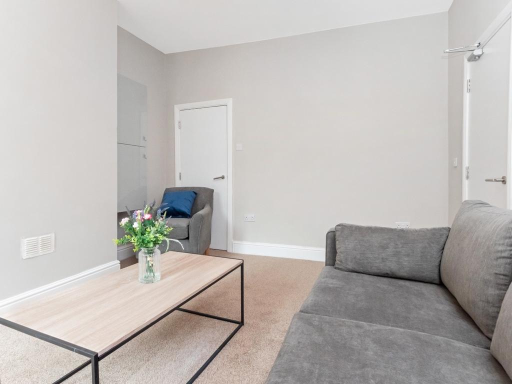 This inviting living room features a cozy sofa ...
