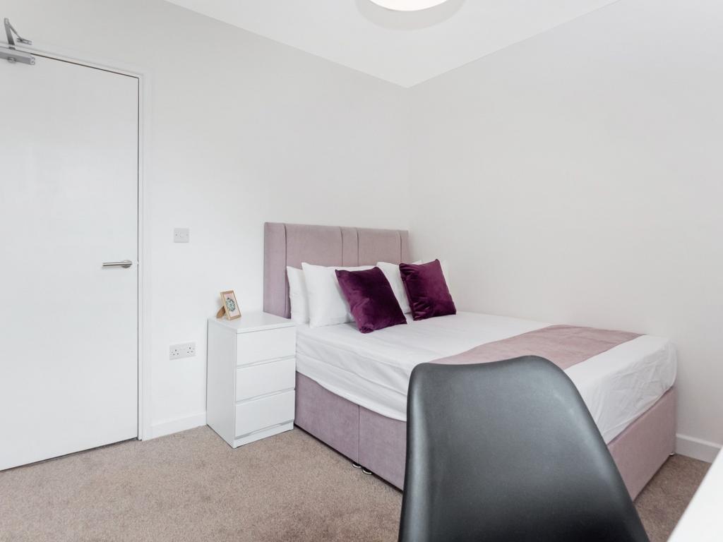 This stylish double bedroom offers a cozy retre...