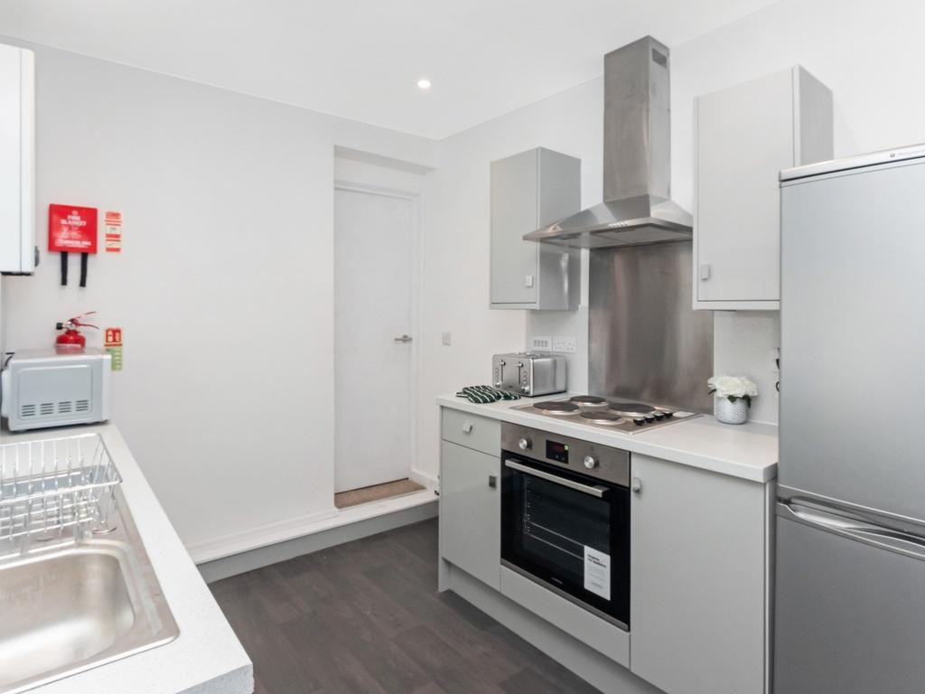 This modern kitchen boasts sleek cabinetry and ...