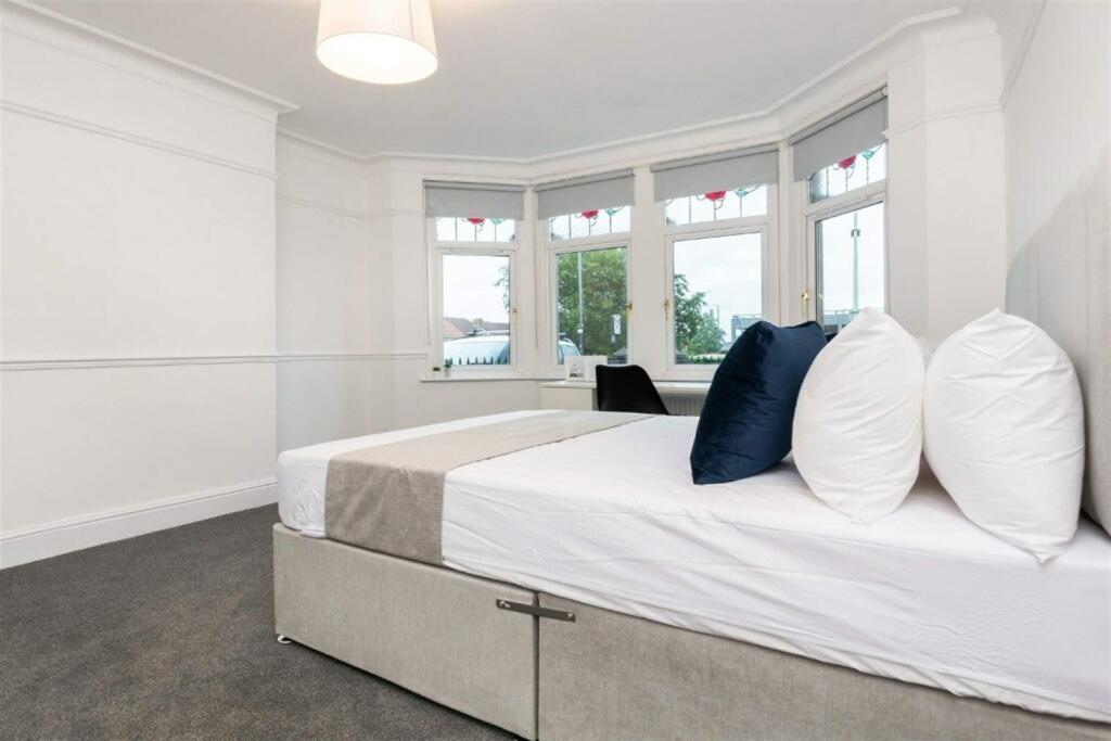 Bright double bedroom featuring a large bay win...