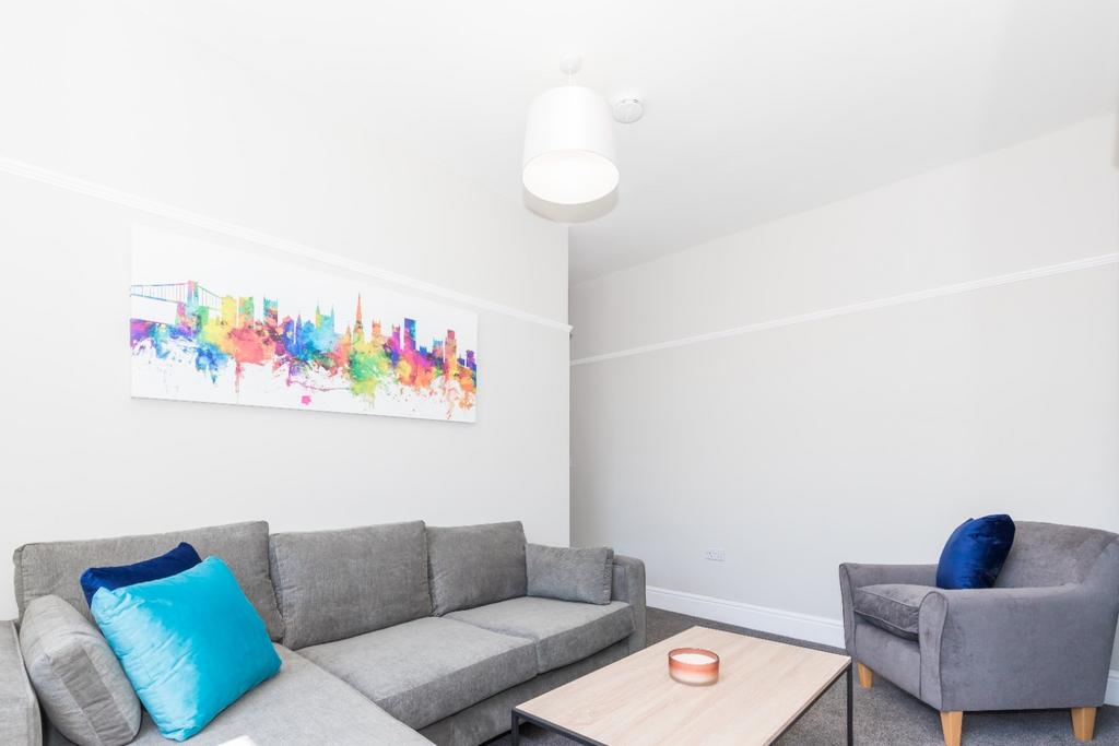 This contemporary living room features a spacio...
