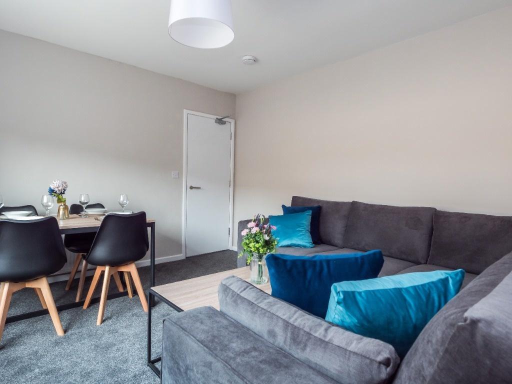 A modern and cozy living room featuring a styli...