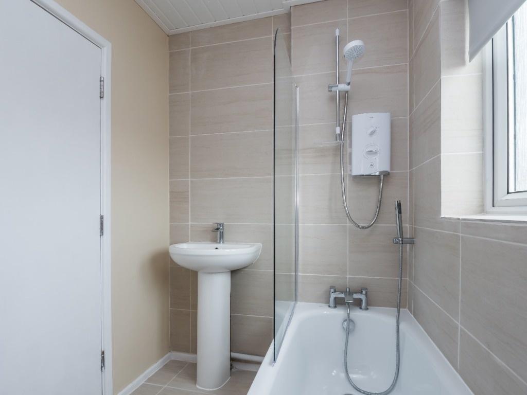 A modern and clean bathroom suite featuring a b...
