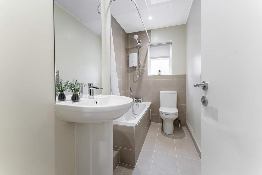 A modern bathroom featuring a clean design with...