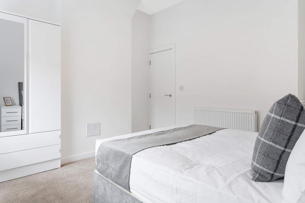 This inviting double bedroom features a comfort...