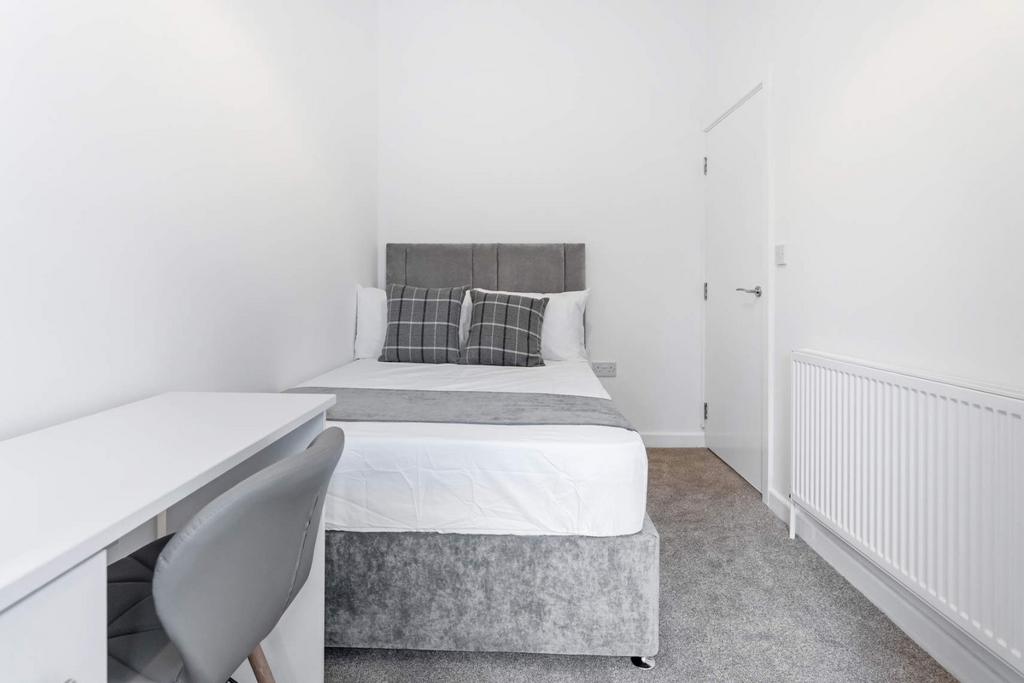 This inviting double bedroom features a comfort...