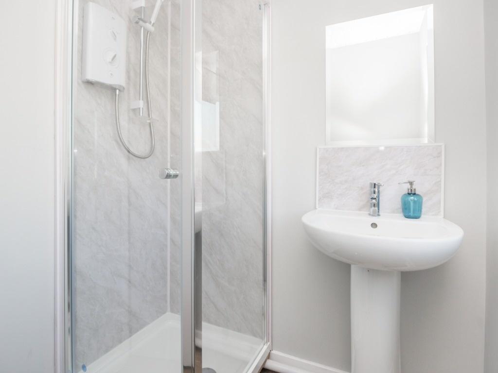 Bright, modern bathroom featuring a clean pedes...