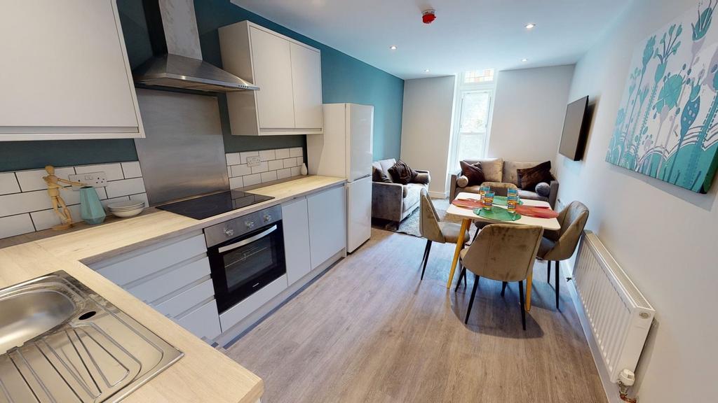 A bright and modern kitchenette with ample spac...