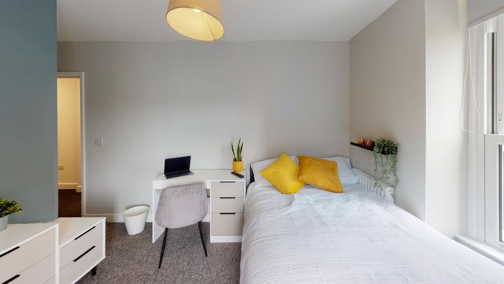A bright and inviting double bedroom featuring ...
