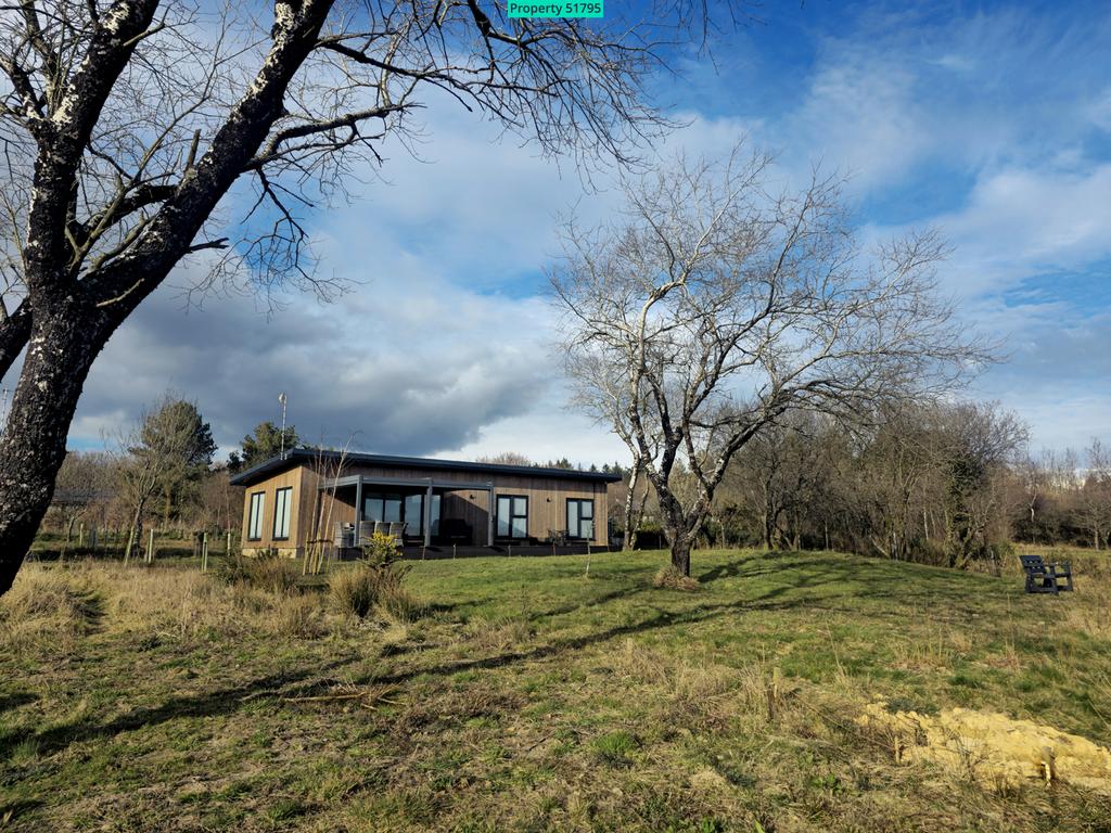 Tranquil setting of an existing holiday lodge abov