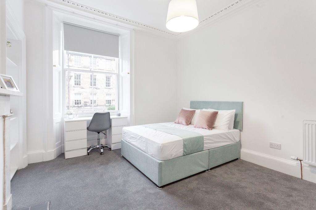 Bright and spacious master bedroom featuring a ...