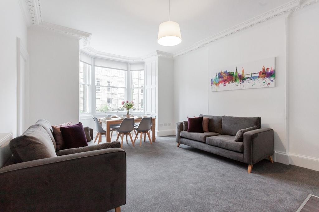 A spacious and bright living room featuring two...