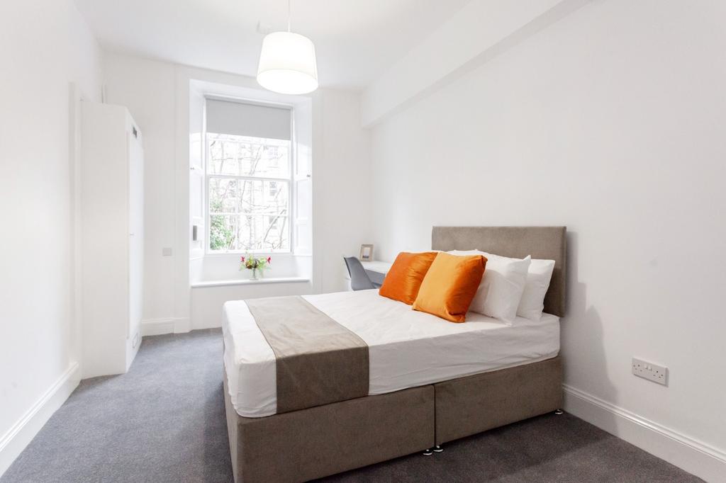 Bright and modern double bedroom featuring a co...
