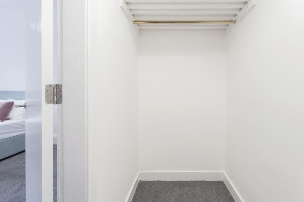 A small, clean storage room with white walls an...