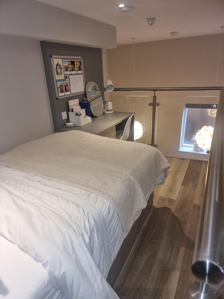 Cozy double bedroom featuring a comfortable bed...