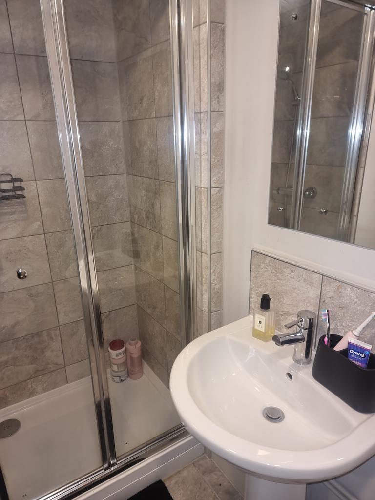 A modern bathroom featuring a sleek shower encl...