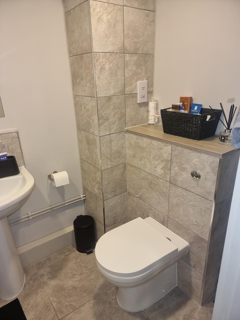 Modern bathroom featuring sleek tiles, a clean ...