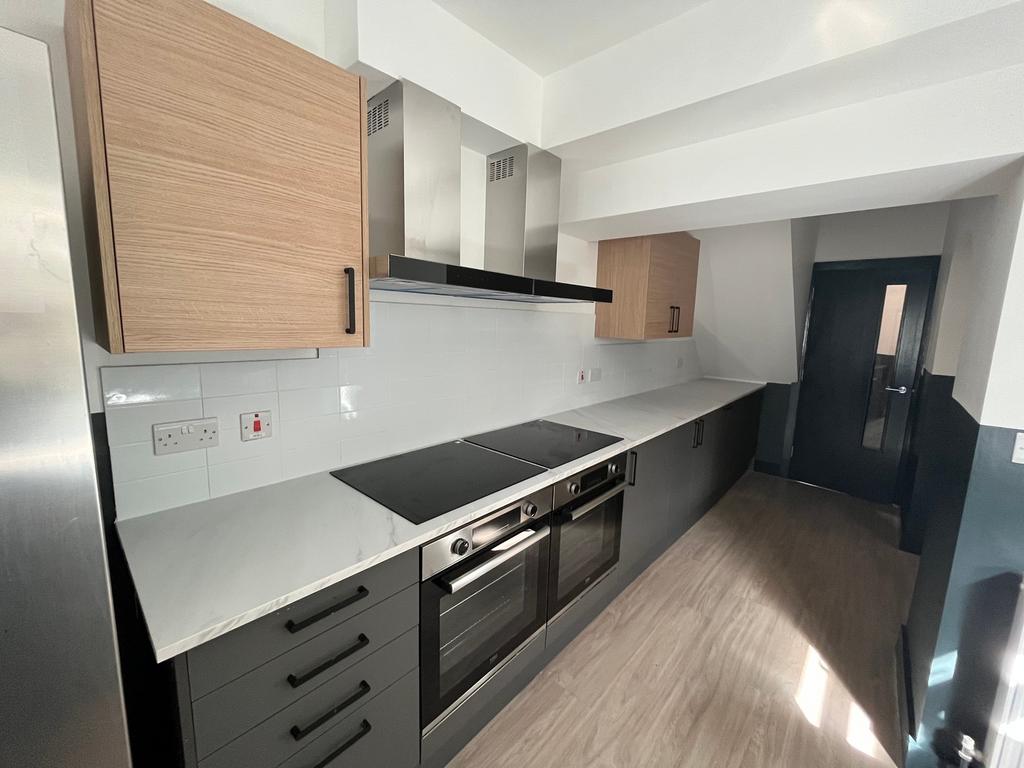 A modern and spacious kitchen featuring ample s...