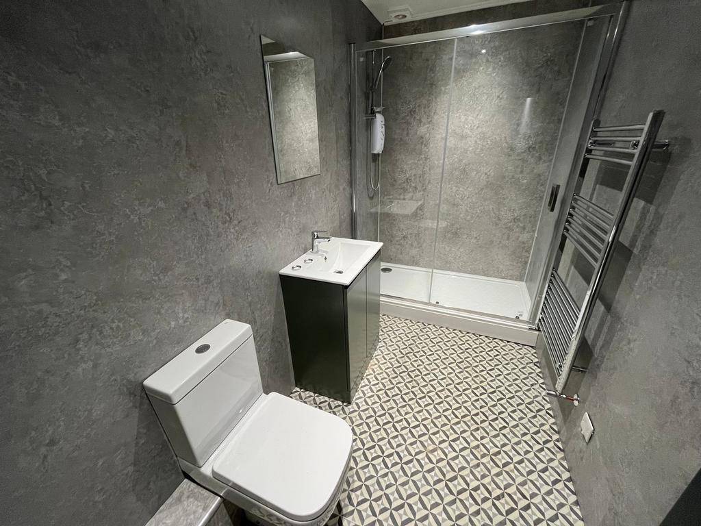 A modern and stylish bathroom featuring a spaci...