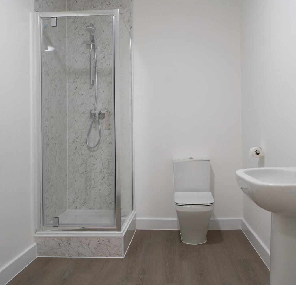 A modern bathroom featuring a sleek shower encl...