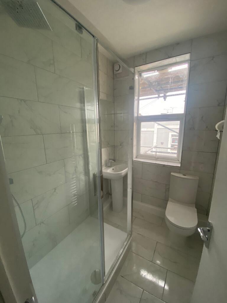 This stylish bathroom features a modern shower ...