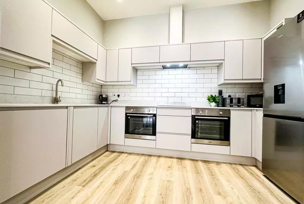 Bright and modern kitchen featuring sleek white...