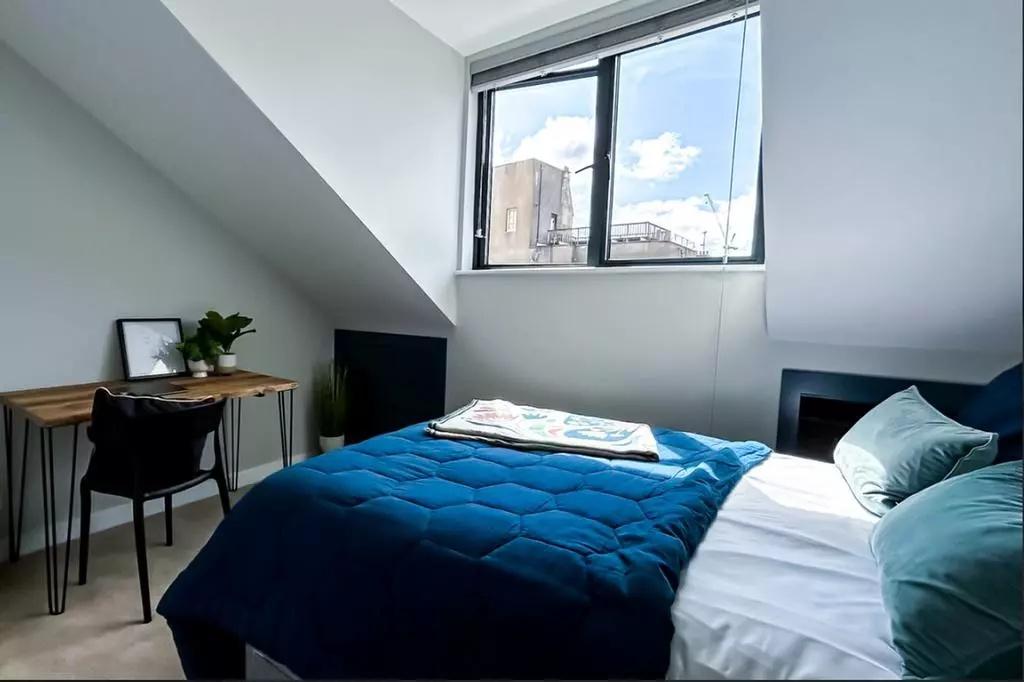 Bright and modern double bedroom featuring a la...