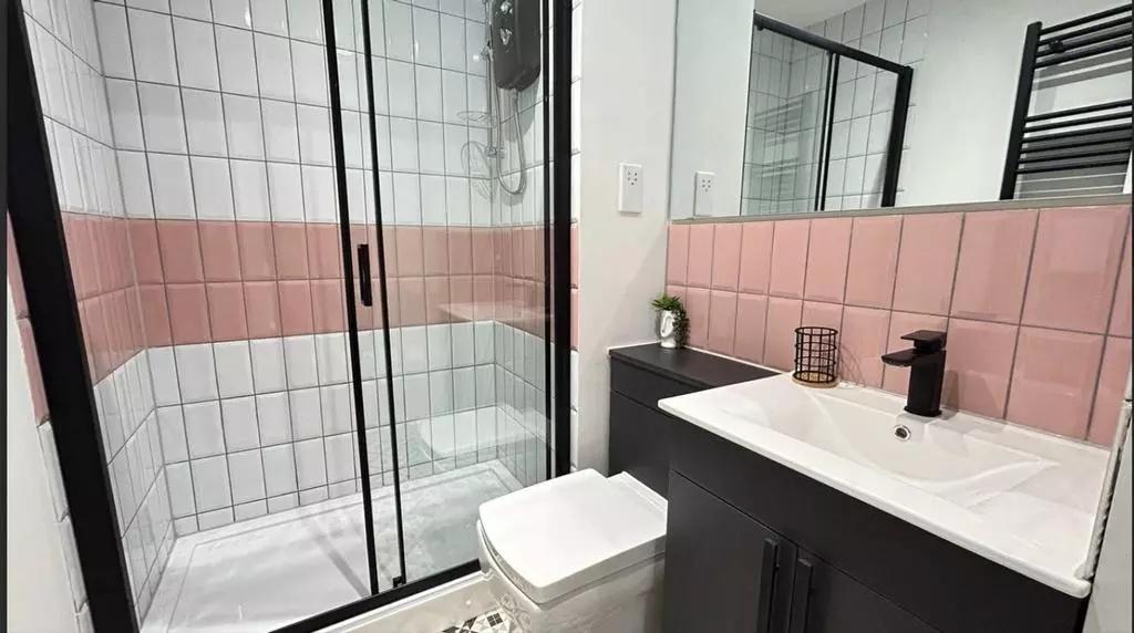 A modern and stylish bathroom featuring a spaci...