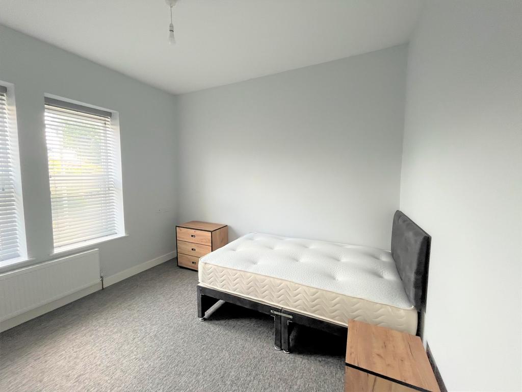 A bright and spacious double bedroom with ample...