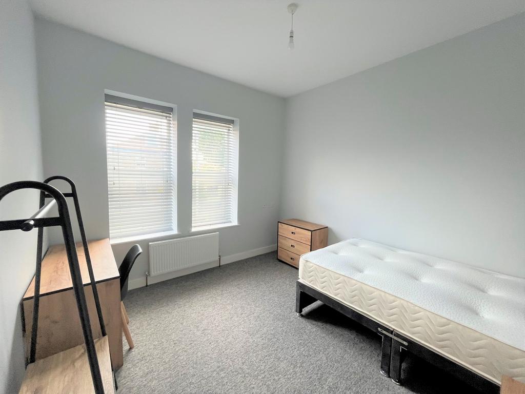 A bright and spacious double bedroom with natur...
