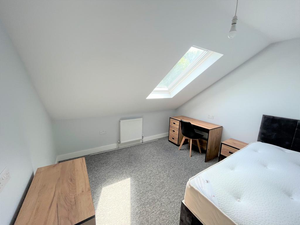 A bright and inviting double bedroom featuring ...