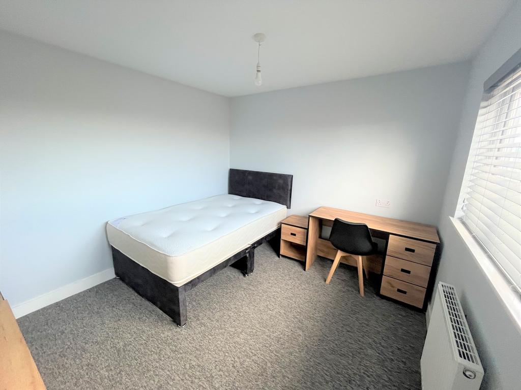 A tidy and bright double bedroom with a modern ...