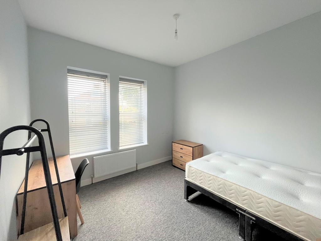 A bright and spacious double bedroom with moder...